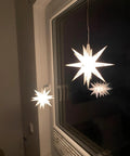 Top Tier Dope E10 LED Light Bulbs 5 Pack 6V Cold White 6500K Miniature Screw Base hanging star decorations in window.