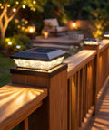 Slick 16 Pack Black Solar Post Cap Lights For 4X4 Wooden Or Vinyl Fences Waterproof dual tone LED on wooden railing at dusk.