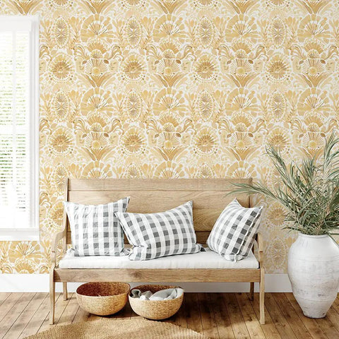 Yellow Boho Bohemia Damask Easy Peel And Stick Wallpaper on wall behind wooden bench with checkered pillows, 20.5in by 16.5ft size.