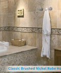 Bathroom with brushed nickel wall mount towel hooks set holding white robe