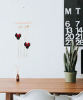 Modern minimalist workspace with a calendar, potted plant, and decorative wall hanging.
