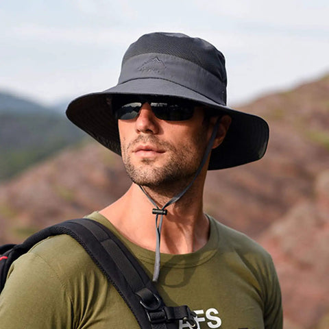 Man wearing Unisex Sun Hat With 360 Degree UV Protection, Wide Brim, Adjustable Chin Strap, Dark Grey, in outdoor setting.