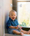 2 Pack Childproof Safety Locks For Refrigerator, Cabinets And Windows in use on a window, child playing safely nearby