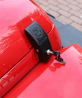 Locking Hood Latch Kit For Jeep Wrangler Skull Style Aluminum Alloy Hood Locks installed on red Jeep with key in lock