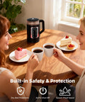 Two people enjoying coffee at a table with an Electric Tea Kettle With Temperature Control And Glass Body, desserts, and mugs.