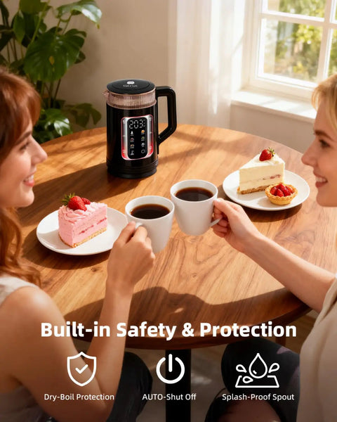 Two people enjoying coffee at a table with an Electric Tea Kettle With Temperature Control And Glass Body, desserts, and mugs.