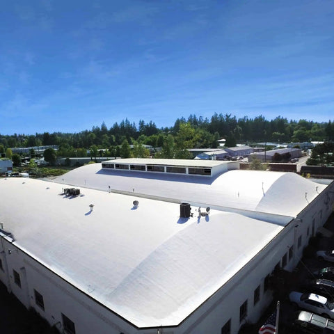 Max Stretch Roof Coating White Elastomeric Sealant For Flat And Low Slope Roofs One Gallon Resists Cracking With Six Hundred Fifty Percent Elongation And Eighty Eight Percent Light Reflectivity That Helps Lower Cooling Costs applied on a large flat roof