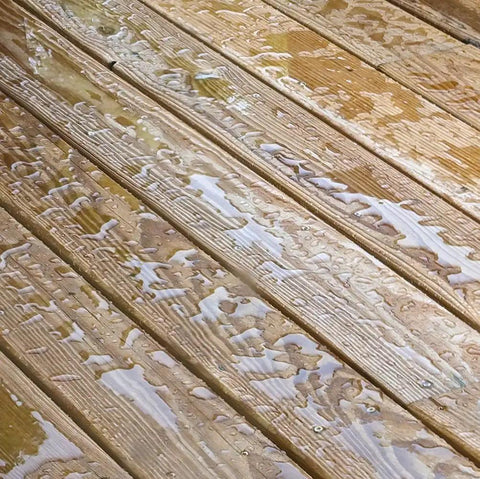 Water beads on treated wood deck surface showing effectiveness of No Sweat Water Repellent Sealant For Concrete Brick Stone Stucco And Wood Decks Breathable Clear Finish Tough As Nails Shields Pavers Fencing Docks From Heavy Rains With Easy Ready To Use Spray Formula In A Generous Five Gallon Jug.