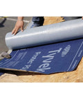 Peel And Stick Roofing Underlayment Ice Dam Blocker Tough As Nails Waterproof Deck Shield Slip Resistant Walking Surface For Asphalt Shingles 3 By 67 Feet Single Roll being unrolled on a roof surface.