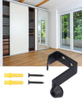 Rock Solid Stainless Steel Door Stopper With Hook, wall-mounted, black finish with screws and plugs, shown in room setting