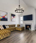 Six Light Wagon Wheel Chandelier In Black Industrial Farmhouse Style hanging in modern living room with rustic charm
