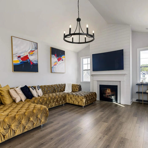 Six Light Wagon Wheel Chandelier In Black Industrial Farmhouse Style hanging in modern living room with rustic charm