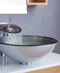 USZWBY Tempered Glass Bathroom Vessel Sink, Round Shape Spiral Pattern with Waterfall Faucet streaming water.