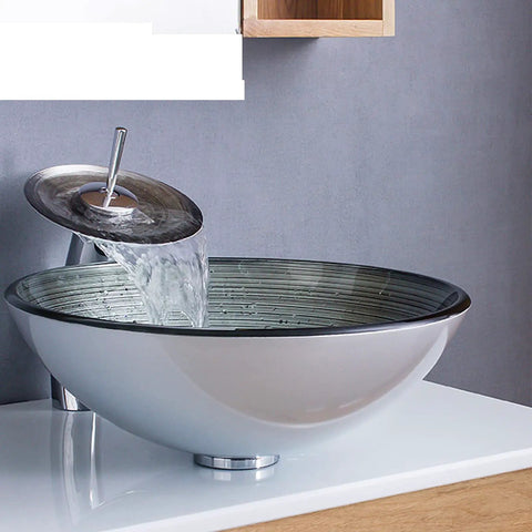 USZWBY Tempered Glass Bathroom Vessel Sink, Round Shape Spiral Pattern with Waterfall Faucet streaming water.