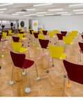 Chairs with colorful tennis ball glides for floor protection in a room showcasing 12 Pack Precut Tennis Ball Glides for Walkers.
