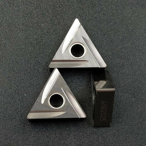 Two silver TNMG triangular carbide turning inserts with a central mounting hole; includes a dark NX25 piece