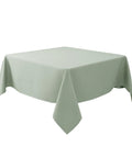 54x54 Inch Sage Square Tablecloth, Linen Like, Water Resistant And Washable, draped over a square table, showcasing its elegant look.
