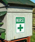 First Aid Station Nurse Symbol Safety Warning Sign 8x12 Aluminum Plaque on wooden outdoor structure with green roof