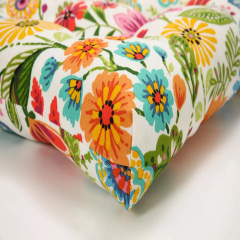 Close-up of bright floral indoor outdoor tufted wicker chair pad with ties set of 2 15.5 x 16 inches cushions pattern