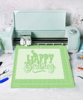 Gwybkq 12x12 green cutting mat with grid and 'Happy Birthday' design; adhesive non-slip, Cricut-style cutter.