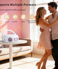 Couple dancing near an All In One Portable Boombox CD Player With Bluetooth For Home Or Outdoors on table