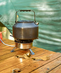 Portable Stainless Steel Picnic Cutlery Set With Organizer Reusable Fork And Spoon on camping table next to kettle