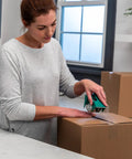 Woman sealing a box with EZ Start Clear Packing Tape Refills For Shipping Moving And Storage 6 Rolls 1.88 Inch By 55 Yards