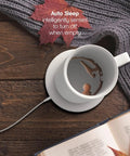 Heavy Duty 12 Oz Stainless Steel Self Heating Coffee Mug With Lid And Smart Charging Coaster on wooden table with book.