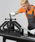 User operating 1.5 Inch Manual Metal Tube Bender Heavy Duty Steel Tabletop Pipe Bending Tool W/ Mold Set For Repair Shop Pipeline Construction.