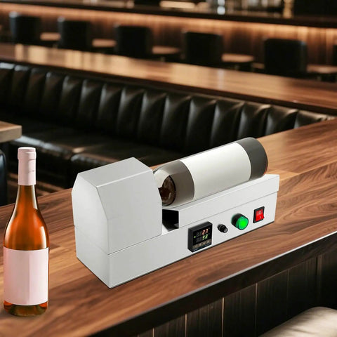 Electric PVC Wine Bottle Capsule Heat Shrinker on a bar top, sealing a wine bottle with a white sleeve for home brewing.