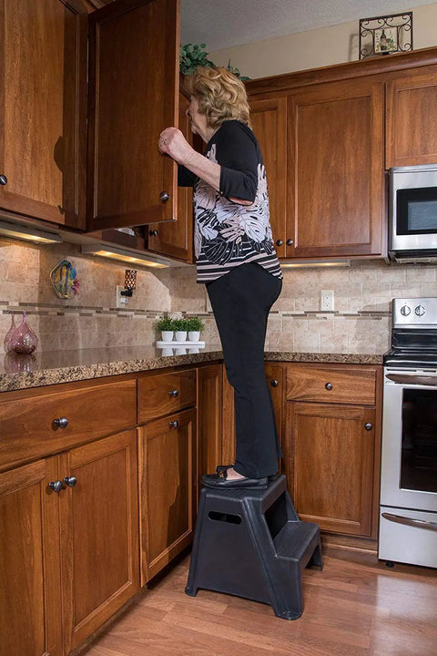 Woman using 2 Step Molded Plastic Step Stool Lightweight With Slip Resistant Treads And Non Slip Feet Ideal For Kitchen