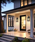 Top Shelves Two Pack Of 17 Inch Exterior Wall Sconces For House Facades showing matte black lights beside a modern porch entrance.