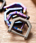 Alloy Miniature Keychain Clip With Detachable Tool And Screwdriver in vibrant multicolor on a wooden surface