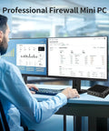 Fanless Firewall Mini Pc Powered By Intel J3710 Chipset And Four Native Two Point Five Gbps Ports With Aes Ni Support For Smashing Through Heavy Traffic And Running A Sleek Barebone Network Gateway Today, shown on a desk with dual monitors.