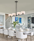 Rectangular Farmhouse Wood Pendant Light With 4 Light Industrial Chandelier over modern kitchen dining area.