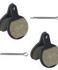 Two black Tektro IOX.11 disc brake pads with speckled friction material and mounting pins
