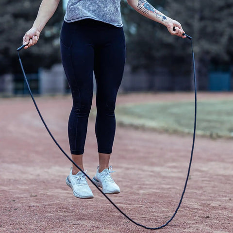 Person using Beaded Jump Rope 1-Inch Beads, Adjustable Length For Cardio, Agility And HIIT Training on outdoor track