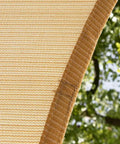 Close-up of beige 8 by 10 foot shade sail canopy for outdoor patio 95 percent UV block water permeable and breathable HDPE mesh 200GSM