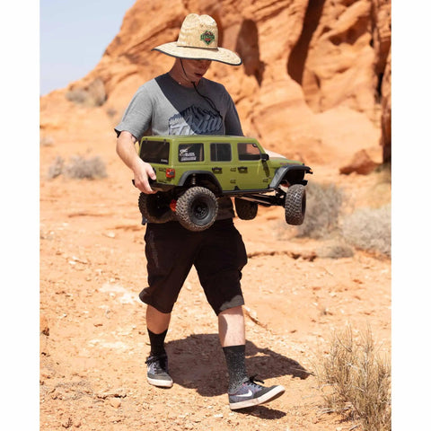 Person holding One Sixth Scale SCX6 Jeep Wrangler 4x4 Rock Crawler RTR With Two Speed Transmission and Beefed Up Front and Rear Suspension