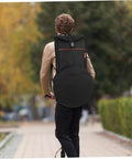 Man using Heavy Duty Waterproof Dumb Drum Storage Bag Premium Oxford Percussion Hauler while riding a scooter.