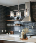 Sloane 31-Inch 3-Light Modern Industrial Farmhouse Island Light With Clear Glass Shades in a brushed nickel finish over kitchen island