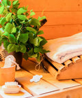 Sauna scene with wooden bench, towel, herbal plants, brushes, and Sauna Steamer Connector Hose Joint Durable Plastic Replacement Fitting