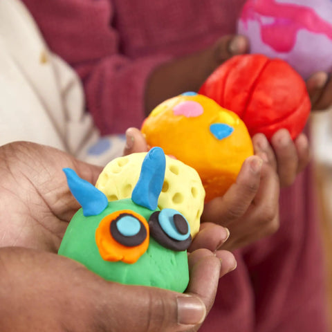 Game Changing Modeling Compound Haul With 65 Mini Cans showing colorful clay creations in kids' hands
