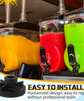 Four beverage dispensers in blue, yellow, red, and green with taps on a counter