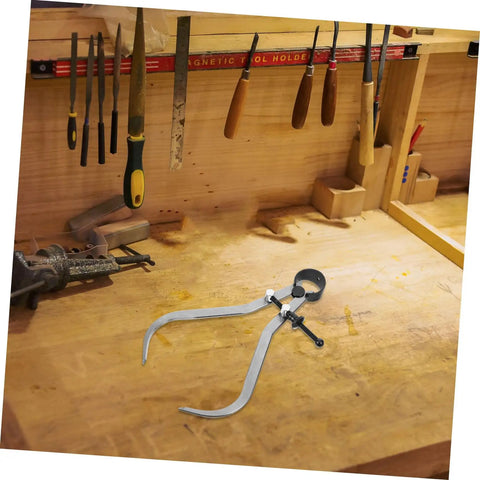 The Real Deal Heavy Duty Outside Caliper For Woodturning Precision Measuring Tool Built Tough Using Premium Carbon Steel on a woodwork bench.