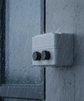 Grey enclosure with eight pack black IP68 waterproof industrial breather vents with M12x1.5 pressure equalization valves in rain.
