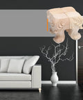 4 Pcs Solid Wood Furniture Legs With Rose Carved Design, displayed hovering near a modern sofa in a stylish room.