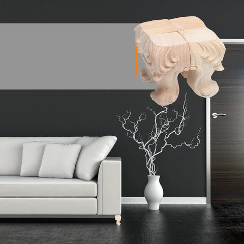 4 Pcs Solid Wood Furniture Legs With Rose Carved Design, displayed hovering near a modern sofa in a stylish room.