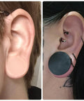 Close-up of ears wearing 22mm Black Silicone Ear Gauges Tunnels Plugs Set Of 3 Pairs In White And Flesh Colors with double flare.
