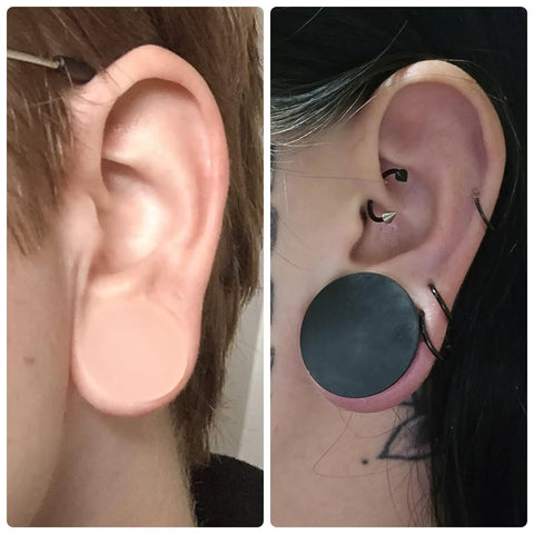 Close-up of ears wearing 22mm Black Silicone Ear Gauges Tunnels Plugs Set Of 3 Pairs In White And Flesh Colors with double flare.